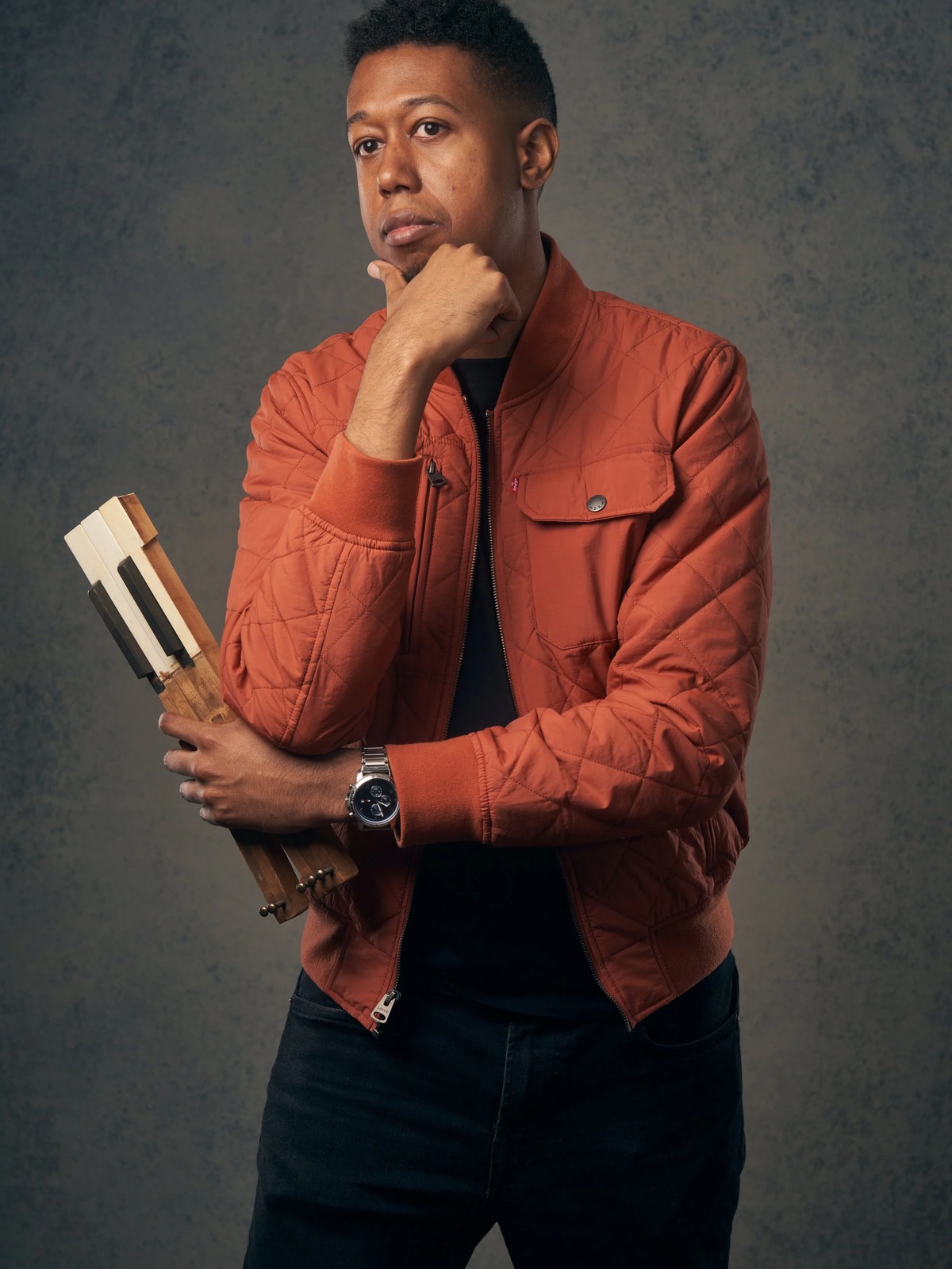 Lawrence Fields portrait in a rust-colored jacket